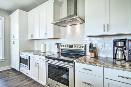 a kitchen with white cabinets and a stove top oven at 2 Mi to Bethany Beach Upscale Coastal Home! in Ocean View
