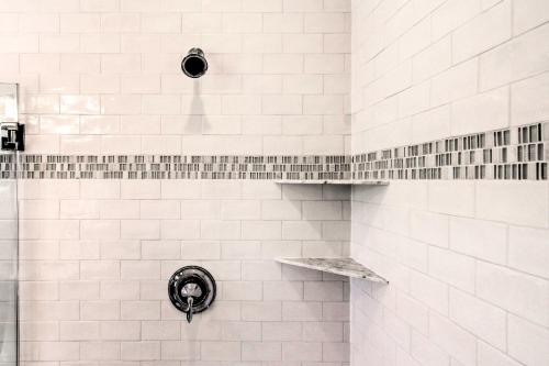 a white tiled shower with a shower head at 2 Mi to Bethany Beach Upscale Coastal Home! in Ocean View