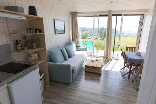 a living room with a couch and a table at Terre d'Horizon Auvergne in Chastreix