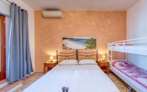 a bedroom with a bed and a bunk bed at S. Lucia in Arzachena