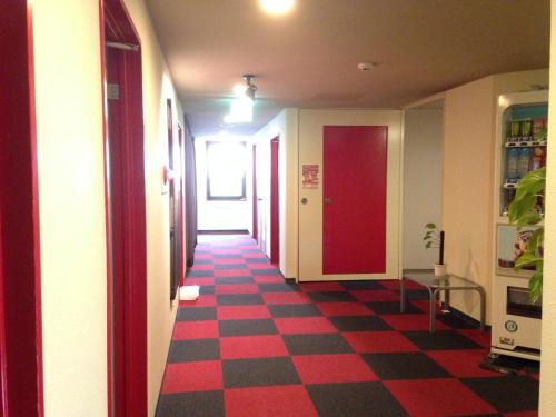 a hallway with a red and black checkered floor at Nagano Plaza Hotel in Nagano