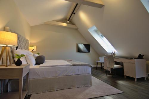 a bedroom with a bed and a desk with a computer at Hotel Florian&Godler in Karlovac