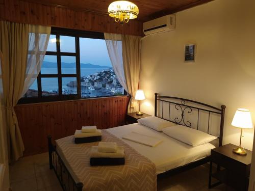 a bedroom with a bed and a large window at Hydra's View House in Hydra