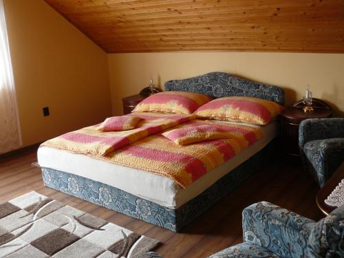 a bedroom with a bed with two pillows on it at Zsuzsi Apartman in Zalakaros