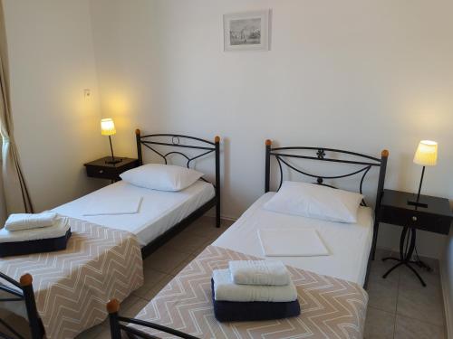 two beds sitting next to each other in a room at Hydra's View House in Hydra