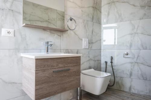 a bathroom with a sink and a toilet at Wait 'n Sea in Himare
