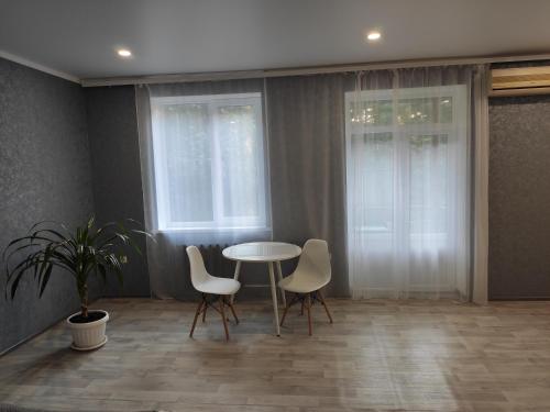 a dining room with a table and two chairs at New apartments Уютная студия в центре города Дзержинка in Kryvyi Rih