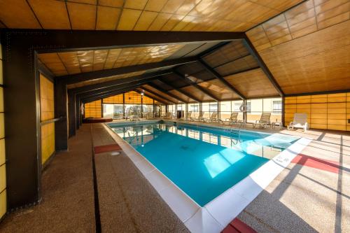 a large swimming pool in a building at Red Roof Inn & Suites Newburgh - Stewart Airport West Point in New Windsor