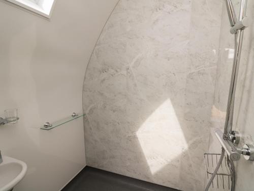 a bathroom with a shower and a sink at Seren in Llandrindod Wells