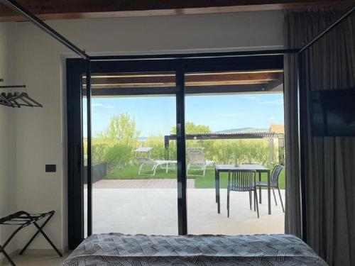 a bedroom with a sliding glass door to a patio at Radici Luxury B&B in Monsampolo del Tronto