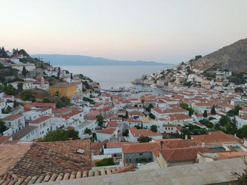 a view of a town with houses and the water at Hydra's View House in Hydra