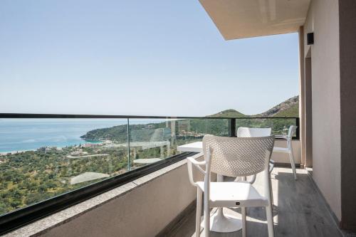 a balcony with chairs and a view of the ocean at Wait 'n Sea in Himare