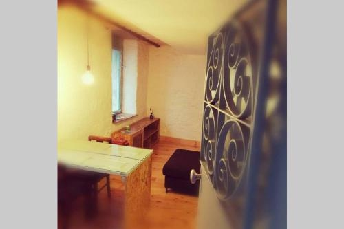 a living room with a table and a dining room at Viela alojamentos Amarante in Amarante