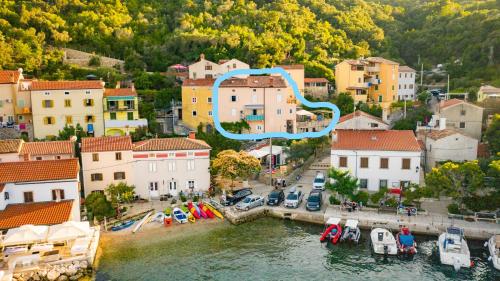 an aerial view of a town with boats in the water at Room Dinko in Valun