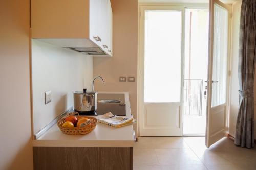 a kitchen with a bowl of fruit on a counter at Country House Ca'Balsomino in Urbino