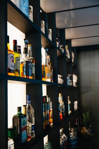 a shelf filled with lots of bottles of alcohol at Hotel Soča in Bovec