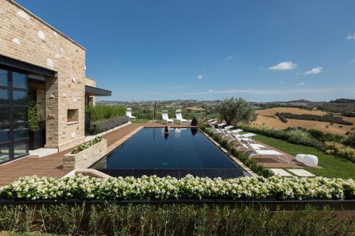 a swimming pool in the backyard of a house at Radici Luxury B&B in Monsampolo del Tronto