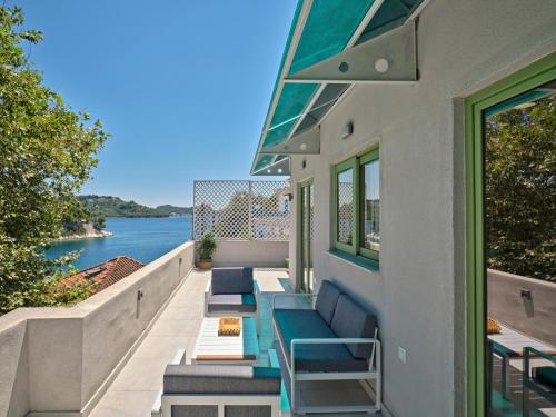 a balcony with benches and a view of the water at The Tree in Skiathos Town