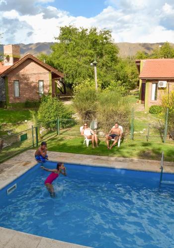 a group of people playing in a swimming pool at La Morada in Merlo