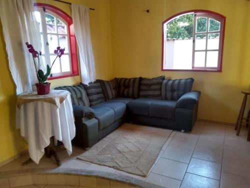 a living room with a couch and a table at Casa Batista in Tiradentes