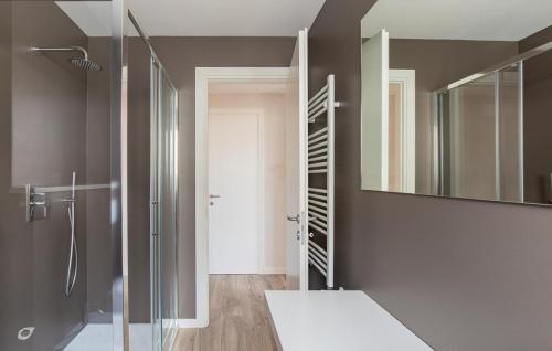 a bathroom with a shower and a mirror at Beachfront Penthouse with private parking in Camaiore