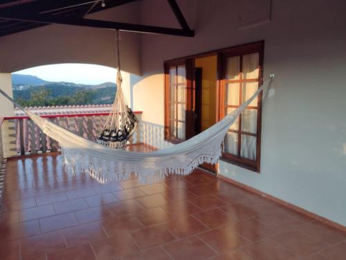 a hammock on the balcony of a house at Casa Batista in Tiradentes