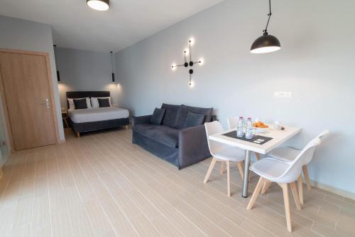 a living room with a table and a couch at Preveza Suitestay Apartments Dodonis 28 in Preveza