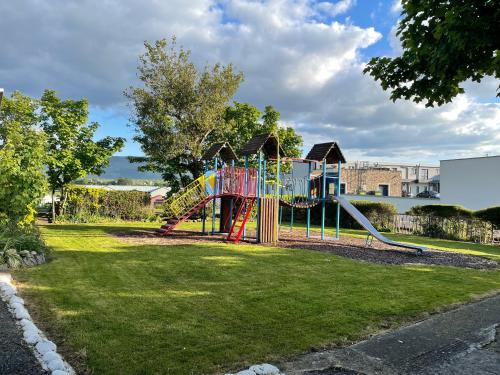 a playground with a slide in a park at Atlantic Apartotel in Bundoran