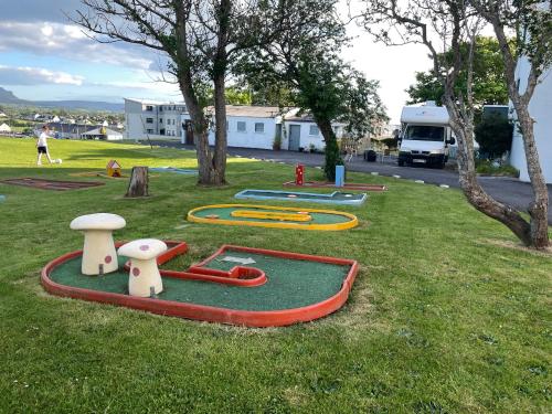 a park with some play equipment in the grass at Atlantic Apartotel in Bundoran