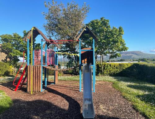 a park with a playground with a slide at Atlantic Apartotel in Bundoran