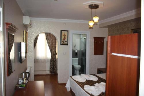 a hotel room with a bed and a bathroom at Big Apple Hotel in Istanbul