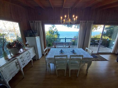 a dining room with a table and chairs and a large window at ESTANCIA LOS BOLDOS in Molina