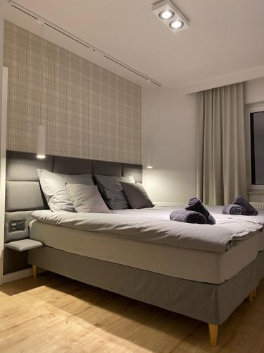 a bedroom with a large bed in a room at Apartament Opieszyn 16 in Września