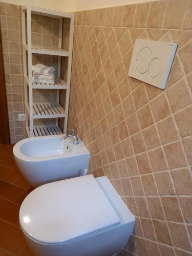 a bathroom with a white toilet and a sink at Agriturismo Fonteregia in Montecatini Terme
