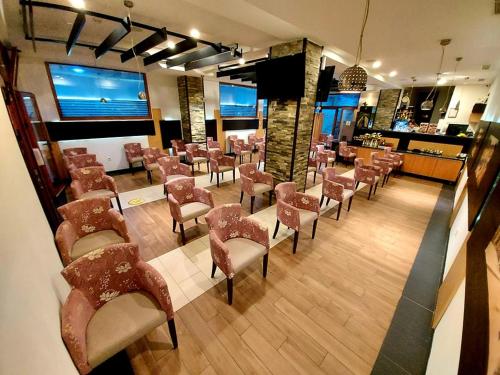 a waiting room with a bunch of chairs and a bar at Hotel Blagaj Mostar in Blagaj