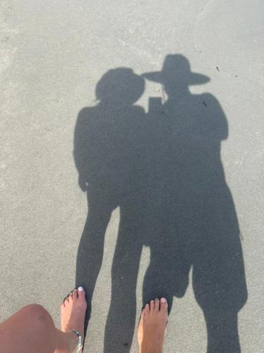 a shadow of a man and a woman on the beach at älanacasadeplaya in San Bernardo del Viento