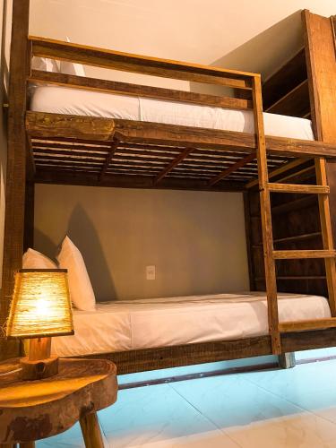 a bunk bed in a room with a lamp and a table at 3 Piratas in Prea