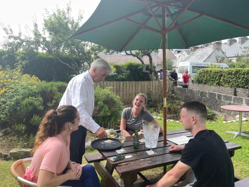 a group of people sitting around a picnic table at Atlantic Apartotel in Bundoran