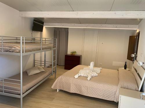 a bedroom with two bunk beds and a room with at Villaggio Camping Bosco Selva in Alberobello
