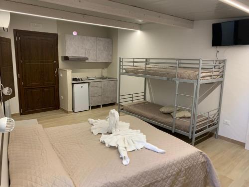 a room with two bunk beds and a kitchen at Villaggio Camping Bosco Selva in Alberobello