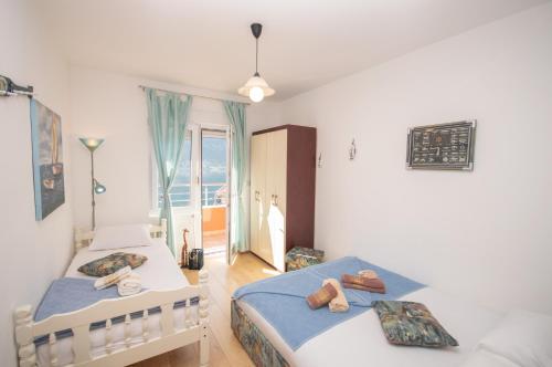 a bedroom with two beds and a window at Apartmani Mrsic in Risan