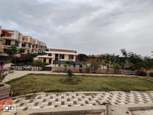 a house with a lawn in front of a building at ROYAL MEADOWS - IGATPURI Bungalow C in Igatpuri