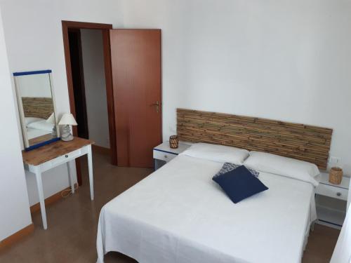 a bedroom with a bed with a mirror and a table at Casa tra Cielo e Mare in Lipari