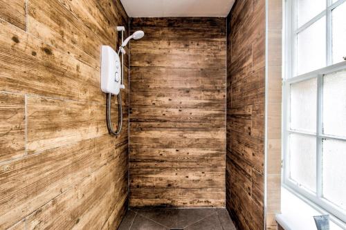 a bathroom with a wooden wall at Haystack Hostel in Edinburgh