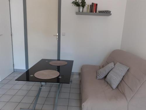 ein Wohnzimmer mit einem Sofa und einem Tisch in der Unterkunft Chez Celine in Rocamadour