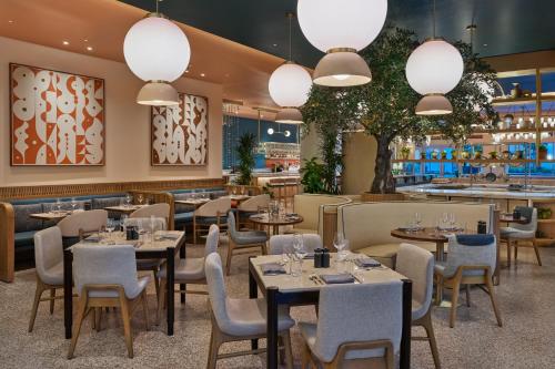a restaurant with tables and chairs and lights at The Seabird Ocean Resort & Spa, Part of Destination Hotel by Hyatt in Oceanside