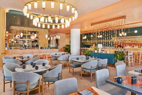 a restaurant with tables and chairs and a bar at The Seabird Ocean Resort & Spa, Part of Destination Hotel by Hyatt in Oceanside