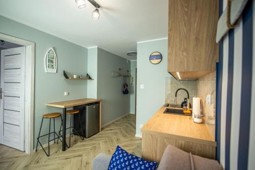 a kitchen with a sink and a counter top at Apartament Omega II in Giżycko