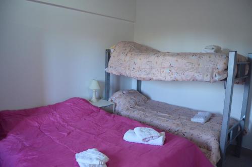 a bedroom with a bunk bed with towels on it at TAID in Esquel
