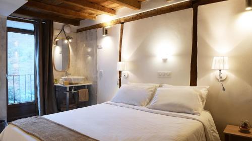 a bedroom with a bed with a sink and a mirror at Au coeur du Village de Lucciana in Lucciana